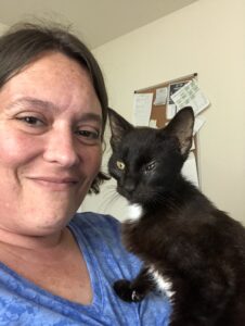 Image of me holding Romeo, showing how skinny he is and his eye infection